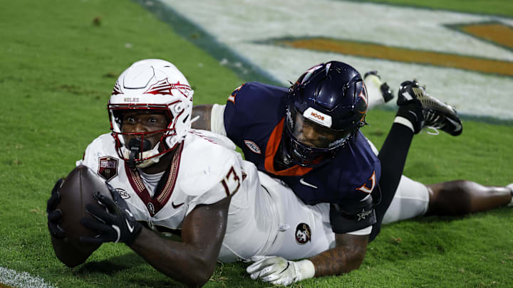 Sep 26, 2025; Charlottesville, Virginia, USA; Florida State Seminoles tight end Randy Pittman Jr. (13) reacts after catching a game tying touchdown pass in the final minute during the fourth quarter in front of Virginia Cavaliers linebacker Kam Robinson (5) during the fourth quarter at Scott Stadium. Mandatory Credit: Geoff Burke-Imagn Images Sep 26, 2025; Charlottesville, Virginia, USA; Florida State Seminoles tight end Randy Pittman Jr. (13) reacts after catching a game tying touchdown pass in the final minute during the fourth quarter in front of Virginia Cavaliers linebacker Kam Robinson (5) during the fourth quarter at Scott Stadium. Mandatory Credit: Geoff Burke-Imagn Images
