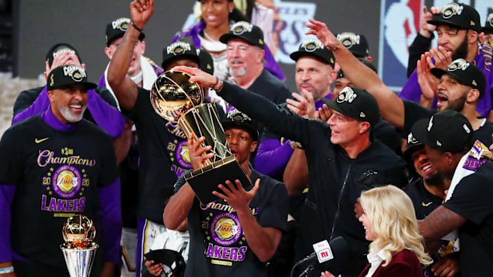Oct 11, 2020; Lake Buena Vista, Florida, USA; Los Angeles Lakers guard Rajon Rondo (9) holds up the Larry O'Brien Trophy after beating the Miami Heat in the NBA Finals.