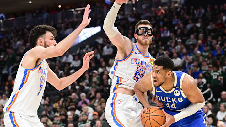 Mar 16, 2025; Milwaukee, Wisconsin, USA;  Milwaukee Bucks forward Giannis Antetokounmpo (34) looks for a shot against Oklahoma City Thunder center Chet Holmgren (7) and center Isaiah Hartenstein (55) in the third quarter at Fiserv Forum. Mandatory Credit: Benny Sieu-Imagn Images