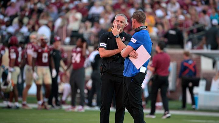 Sep 7, 2026; Tallahassee, Florida, USA;  Florida State Seminoles head coach Mike Norvell and Southern Methodist Mustangs head coach Rhett Lashlee talk during a delay due to a power outage before the game at Doak S. Campbell Stadium.  Mandatory Credit: Melina Myers-Imagn Images