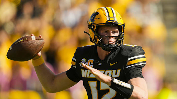 Oct 19, 2024; Columbia, Missouri, USA; Missouri Tigers quarterback Brady Cook (12) throws a pass during the second half against the Auburn Tigers at Faurot Field at Memorial Stadium. Mandatory Credit: Jay Biggerstaff-Imagn Images