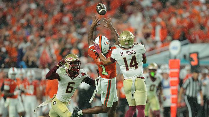 Oct 17, 2026; Miami Gardens, Florida, USA; Miami Hurricanes wide receiver Malachi Toney (1) makes a catch against Florida State Seminoles defensive back Ja'Bril Rawls (6) and defensive back Ma'Khi Jones (14) during the first quarter at Hard Rock Stadium. Mandatory Credit: Sam Navarro-Imagn Images Oct 17, 2026; Miami Gardens, Florida, USA; Miami Hurricanes wide receiver Malachi Toney (1) makes a catch against Florida State Seminoles defensive back Ja'Bril Rawls (6) and defensive back Ma'Khi Jones (14) during the first quarter at Hard Rock Stadium. Mandatory Credit: Sam Navarro-Imagn Images