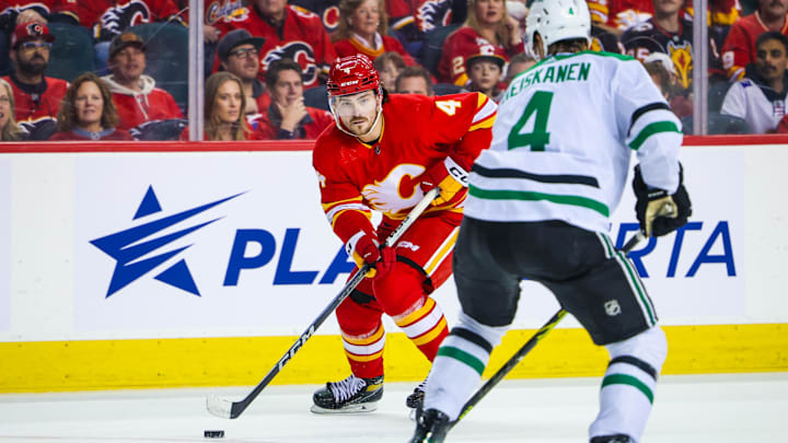 Nov 30, 2023; Calgary, Alberta, CAN; Calgary Flames defenseman Rasmus Andersson (4) controls the puck against the Dallas Stars during the overtime period at Scotiabank Saddledome. Mandatory Credit: Sergei Belski-Imagn Images