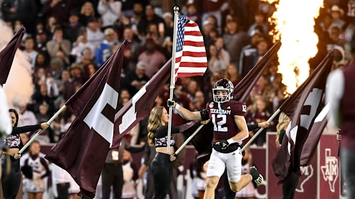 Nov 11, 2023; College Station, Texas, USA; Texas A&M Aggies linebacker Sam Mathews (12) runs out with the American Flag prior to the game against Mississippi State Bulldogs at Kyle Field. Mandatory Credit: Maria Lysaker-USA TODAY Sports