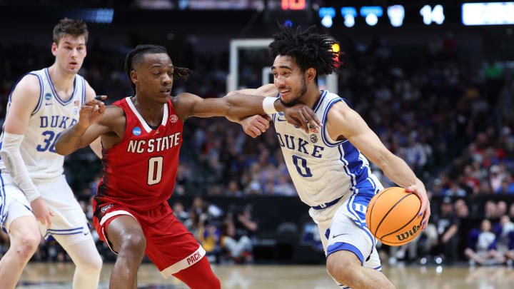 Mar 31, 2024; Dallas, TX, USA; Duke Blue Devils guard Jared McCain (0) controls the ball against North Carolina State Wolfpack guard DJ Horne (0) in the first half in the finals of the South Regional of the 2024 NCAA Tournament at American Airline Center. Mandatory Credit: Kevin Jairaj-USA TODAY Sports