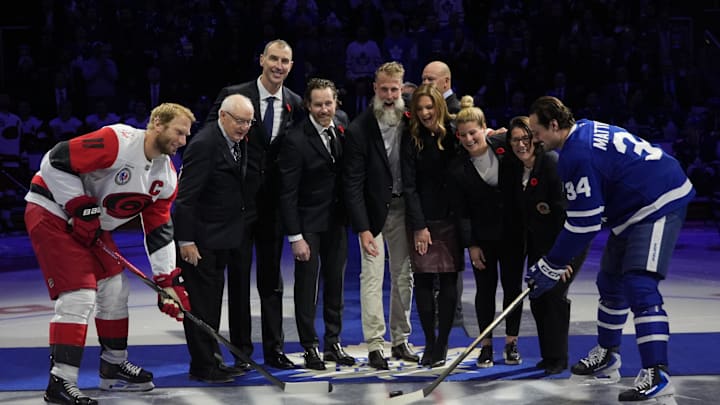 Nov 9, 2025; Toronto, Ontario, CAN; 2025 Hockey Hall of Fame inductees (left to right) Jack Parker, Zdeno Chara,  Duncan Keith, Joe Thornton, Jennifer Botteril, Brianna Decker, and  Daniele Sauvageau drop the puck to Carolina Hurricanes forward Jordan Staal (11) and Toronto Maple Leafs forward Auston Matthews (34) before the start of the game at Scotiabank Arena. Mandatory Credit: John E. Sokolowski-Imagn Images
