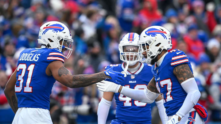 Dec 31, 2023; Orchard Park, New York, USA; Buffalo Bills cornerback Rasul Douglas (31) and cornerback Christian Benford (47) celebrate a turnover against the New England Patriots with linebacker Terrel Bernard (43) in the first quarter at Highmark Stadium.