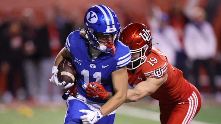 Nov 9, 2024; Salt Lake City, Utah, USA; Brigham Young Cougars wide receiver Parker Kingston (11) returns a punt against Utah Utes wide receiver Luca Caldarella (19) during the second half at Rice-Eccles Stadium. Mandatory Credit: Rob Gray-Imagn Images