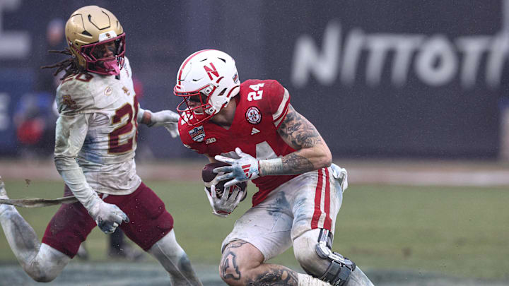 Dec 28, 2024; Bronx, NY, USA; Nebraska Cornhuskers tight end Thomas Fidone II (24) fights for yards as Boston College Eagles defensive back KP Price (20) pursues during the second half at Yankee Stadium. Mandatory Credit: Vincent Carchietta-Imagn Images Dec 28, 2024; Bronx, NY, USA; Nebraska Cornhuskers tight end Thomas Fidone II (24) fights for yards as Boston College Eagles defensive back KP Price (20) pursues during the second half at Yankee Stadium. Mandatory Credit: Vincent Carchietta-Imagn Images