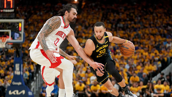 May 2, 2025; San Francisco, California, USA; Golden State Warriors guard Stephen Curry (30) dribbles past Houston Rockets center Steven Adams (12) in the third quarter of game six of the first round for the 2025 NBA Playoffs at Chase Center. Mandatory Credit: Cary Edmondson-Imagn Images