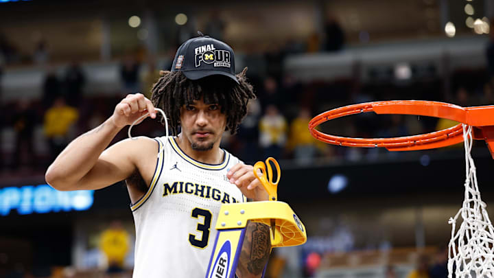 Mar 29, 2026; Chicago, IL, USA; Michigan Wolverines guard Elliot Cadeau (3) cuts the net after defeating Tennessee Volunteers in an Elite Eight game of the Midwest Regional of the men's 2026 NCAA Tournament at United Center. Mandatory Credit: Kamil Krzaczynski-Imagn Images