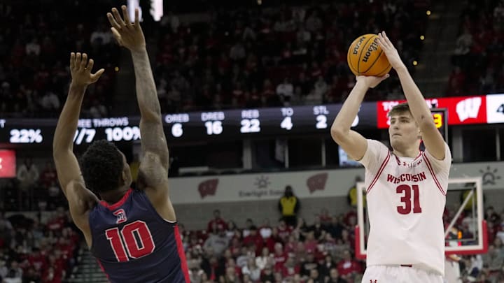 Wisconsin forward Nolan Winter (31) hits a three-point basket over Detroit Mercy guard Nate Johnson (10) during the second half of their game Sunday, December 22, 2024 at the Kohl Center in Madison, Wisconsin. Wisconsin beat Detroit Mercy 76-53.