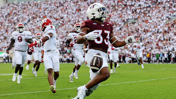 Sep 21, 2024; Blacksburg, Virginia, USA; Virginia Tech Hokies running back Bhayshul Tuten (33) scores a touchdown during the second quarter against the Rutgers Scarlet Knights at Lane Stadium. Mandatory Credit: Peter Casey-Imagn Images