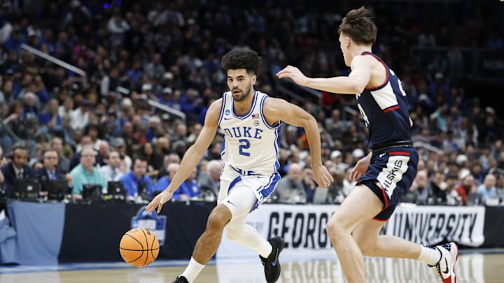 Mar 29, 2026; Washington, DC, USA; Duke Blue Devils guard Cayden Boozer (2) dribbles the ball as UConn Huskies guard Braylon Mullins (24) defends in the first half during an Elite Eight game of the East Regional of the men's 2026 NCAA Tournament at Capital One Arena. 