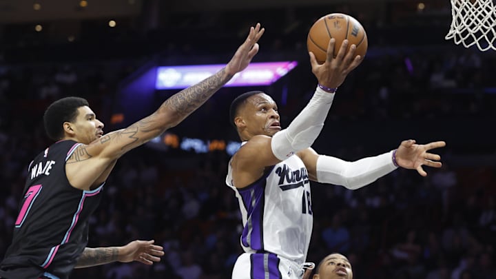 Dec 6, 2025; Miami, Florida, USA;  Sacramento Kings guard Russell Westbrook (18) shoots around Miami Heat center Kel'el Ware (7) during the second half at Kaseya Center. Mandatory Credit: Rhona Wise-Imagn Images