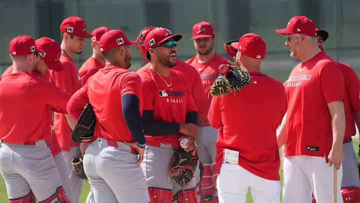 Feb 12, 2025; Jupiter, FL, USA;  St. Louis Cardinals catchers and coaches gather for a meeting during Spring Training. Mandatory Credit: Jim Rassol-Imagn Images