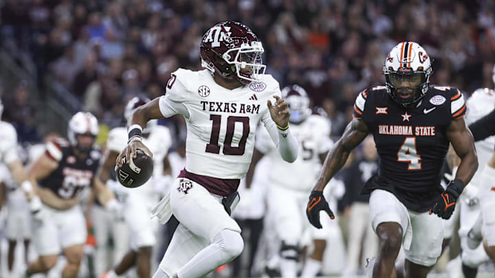 Dec 27, 2023; Houston, TX, USA; Texas A&M Aggies quarterback Marcel Reed (10) runs with the ball as Oklahoma State Cowboys linebacker Nickolas Martin (4) attempts to make a tackle during the first quarter at NRG Stadium. Mandatory Credit: Troy Taormina-Imagn Images