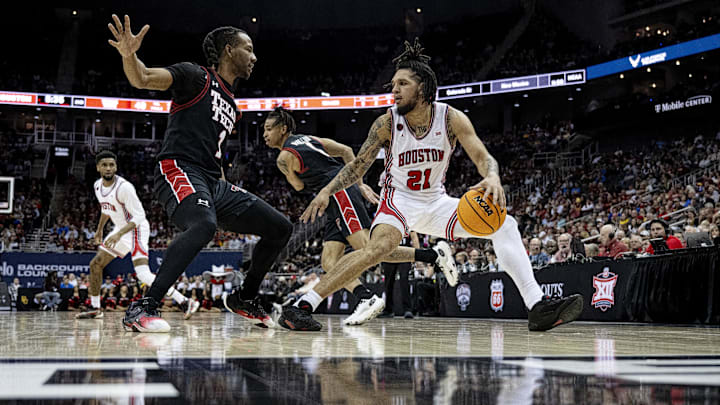 Houston Cougars guard Emanuel Sharp (21) dribbles the ball while defended by Texas Tech Red Raiders guard Lamar Washington (2)