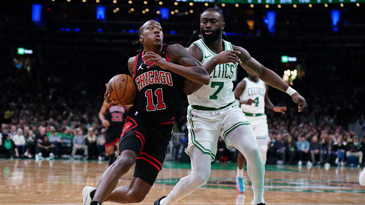 Dec 19, 2024; Boston, Massachusetts, USA; Chicago Bulls guard Ayo Dosunmu (11) drives the ball against Boston Celtics guard Jaylen Brown (7) in the second half at TD Garden. Mandatory Credit: David Butler II-Imagn Images