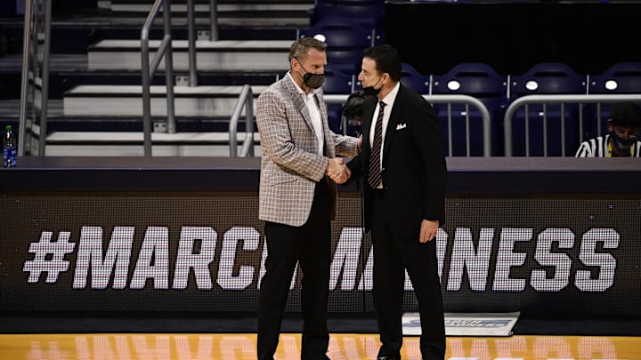 Mar 20, 2021; Indianapolis, Indiana, USA; Alabama Crimson Tide head coach Nate Oats (left) greets Iona Gaels head coach Rick Pitino after their game during the first round of the 2021 NCAA Tournament at Hinkle Fieldhouse. Mandatory Credit: Marc Lebryk-Imagn Images