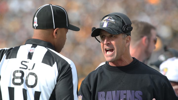 Nov 17, 2024; Pittsburgh, Pennsylvania, USA;  Baltimore Ravens head coach John Harbaugh (right) talks with side judge Alonzo Ramsey II (80) against the Pittsburgh Steelers during the first quarter at Acrisure Stadium. Mandatory Credit: Charles LeClaire-Imagn Images