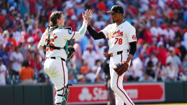 Baltimore Orioles catcher Adley Rutschman (35) and Baltimore Orioles pitcher Yennier Cano.
