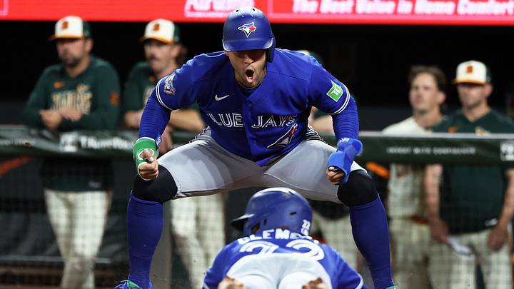 May 29, 2026; Baltimore, Maryland, USA; Toronto Blue Jays designated hitter George Springer (4) celebrates as Toronto Blue Jays shortstop Ernie Clement (22) slides home to score a run during the eighth inning against the Baltimore Orioles at Oriole Park at Camden Yards. 