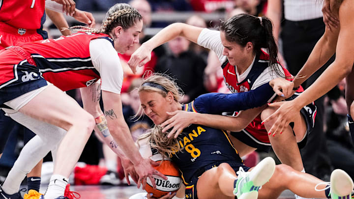 Washington Mystics Emily Engstler (21), Indiana Fever Sophie Cunningham (8) and Washington Mystics Sonia Citron (22) fight for a loose ball Saturday, May 3, 2025, during a preseason game between the Indiana Fever and the Washington Mystics at Gainbridge Fieldhouse in Indianapolis.