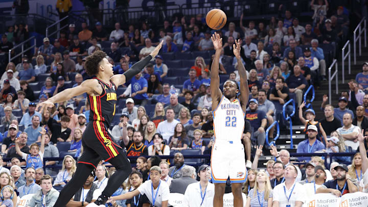 Oct 27, 2024; Oklahoma City, Oklahoma, USA; Oklahoma City Thunder guard Cason Wallace (22) shoots a three point basket as Atlanta Hawks forward Jalen Johnson (1) comes in to defend during the second half at Paycom Center. Mandatory Credit: Alonzo Adams-Imagn Images