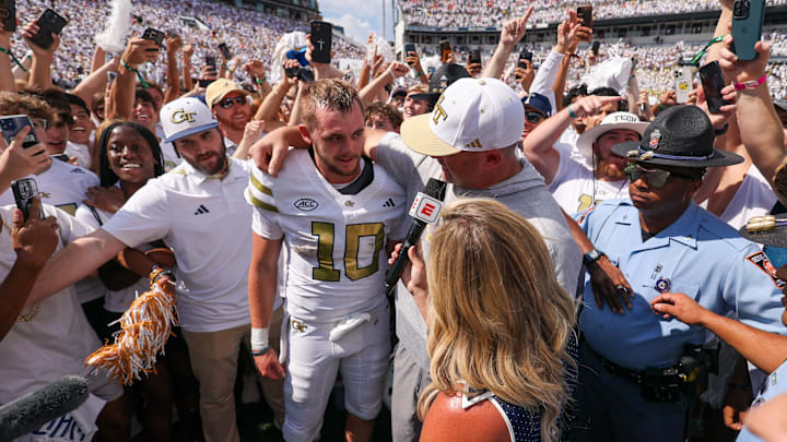 Sep 13, 2025; Atlanta, Georgia, USA; Georgia Tech Yellow Jackets quarterback Haynes King (10) and head coach Brent Key talk to a reporter after a victory over the Clemson Tigers at Bobby Dodd Stadium at Hyundai Field. Mandatory Credit: Brett Davis-Imagn Images