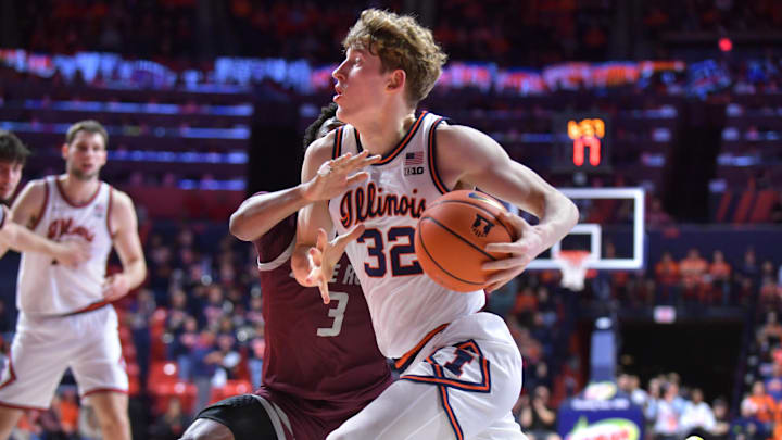 Nov 25, 2024; Champaign, Illinois, USA;  Illinois Fighting Illini guard Kasparas Jakucionis (32) drives against Little Rock Trojans guard Isaiah Lewis (3) during the first half at State Farm Center. Mandatory Credit: Ron Johnson-Imagn Images