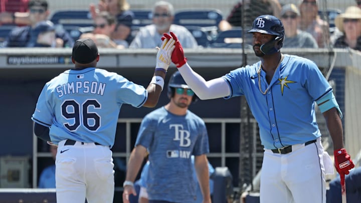 Tampa Bay Rays outfielder Chandler Simpson (96) is congratulated by outfielder Eloy Jimenez during a spring training game. Tampa Bay Rays outfielder Chandler Simpson (96) is congratulated by outfielder Eloy Jimenez during a spring training game.