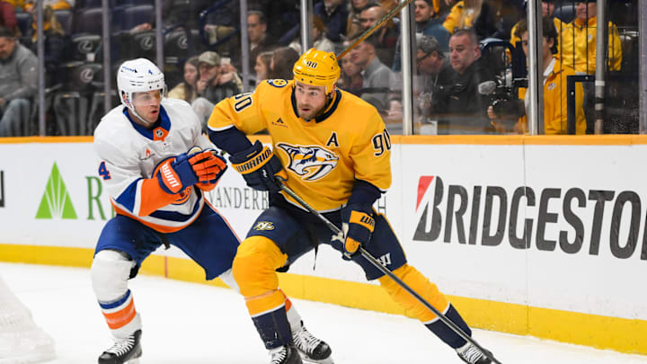 Apr 8, 2025; Nashville, Tennessee, USA;  Nashville Predators center Ryan O'Reilly (90) skates behind the net against the New York Islanders during the third period at Bridgestone Arena. Mandatory Credit: Steve Roberts-Imagn Images