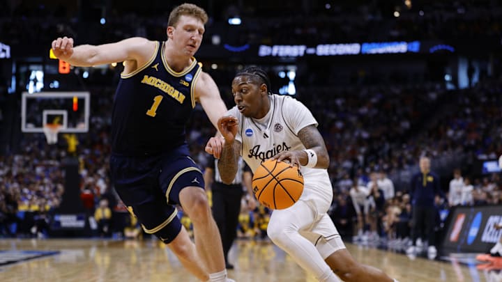 Mar 22, 2025; Denver, CO, USA; Texas A&M Aggies guard Wade Taylor IV (4) dribbles the ball against Michigan Wolverines center Danny Wolf (1) during the second half in the second round of the NCAA Tournament at Ball Arena. Mandatory Credit: Isaiah J. Downing-Imagn Images Mar 22, 2025; Denver, CO, USA; Texas A&M Aggies guard Wade Taylor IV (4) dribbles the ball against Michigan Wolverines center Danny Wolf (1) during the second half in the second round of the NCAA Tournament at Ball Arena. Mandatory Credit: Isaiah J. Downing-Imagn Images