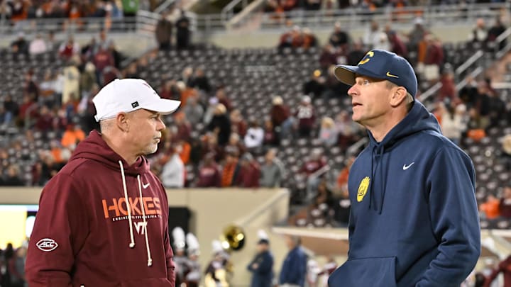 Blacksburg, Virginia, USA;  Virginia Tech Hokies coach Phillip Montgomery and California Golden Bears head coach Justin Wilcox talk before the game at Lane Stadium. 