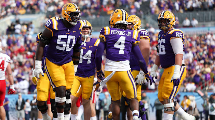 Jan 1, 2024; Tampa, FL, USA;  LSU Tigers offensive lineman Emery Jones Jr. (50) celebrates with