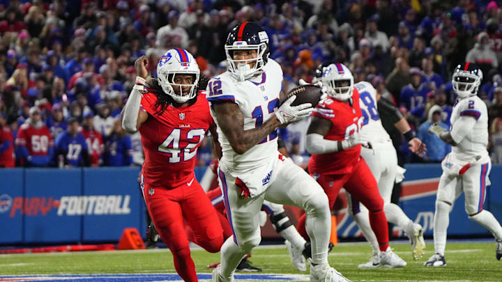 Oct 15, 2023; Orchard Park, New York, USA; New York Giants tight end Darren Waller (12) runs with the ball after making a catch against Buffalo Bills linebacker Dorian Williams (42) during the first half at Highmark Stadium