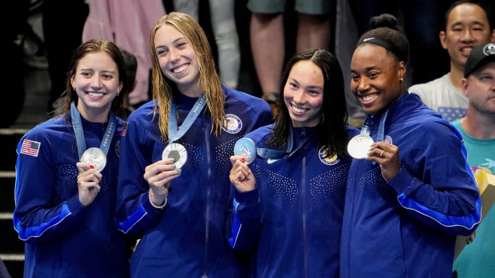 Jul 27, 2024; Nanterre, France; Kate Douglass (USA), Gretchen Walsh (USA), Torri Huske (USA) and Simone Manuel (USA) in the women’s 4 x 100-meter freestyle relay medal ceremony during the Paris 2024 Olympic Summer Games at Paris La Défense Arena. Mandatory Credit: Rob Schumacher-USA TODAY Sports