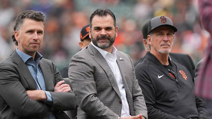 Apr 25, 2026; San Francisco, California, USA; San Francisco Giants general manager Zack Minasian (center) sits with president of baseball operation Buster Posey (left) and special assistant to baseball operations Ron Wotus (right) before the game against the Miami Marlins at Oracle Park. Mandatory Credit: Darren Yamashita-Imagn Images