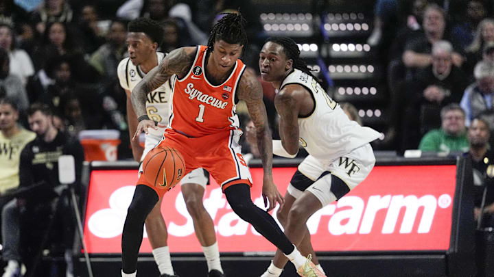 Feb 28, 2026; Winston-Salem, North Carolina, USA; Syracuse Orange forward Donnie Freeman (1) handles the ball defended by Wake Forest Demon Deacons forward Tre'von Spillers (25) during the first half at Lawrence Joel Veterans Memorial Coliseum. Mandatory Credit: Jim Dedmon-Imagn Images