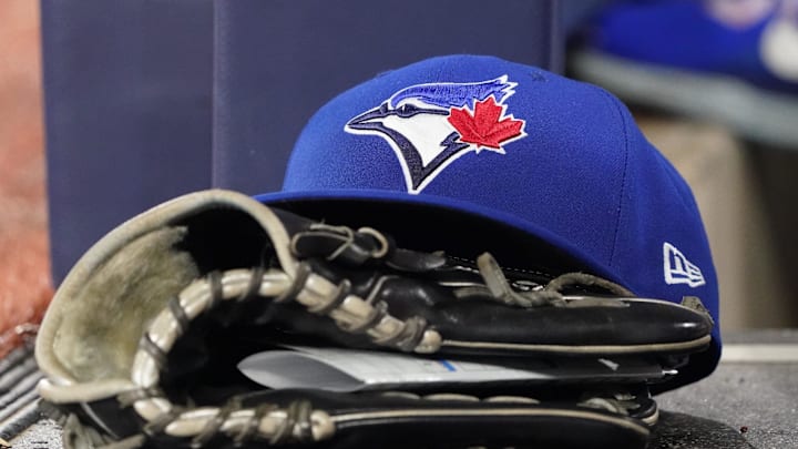 Jun 18, 2025; Toronto, Ontario, CAN; A Toronto Blue Jays cap and glove sits in the dugout during a game against the Arizona Diamondbacks at Rogers Centre. Mandatory Credit: John E. Sokolowski-Imagn Images