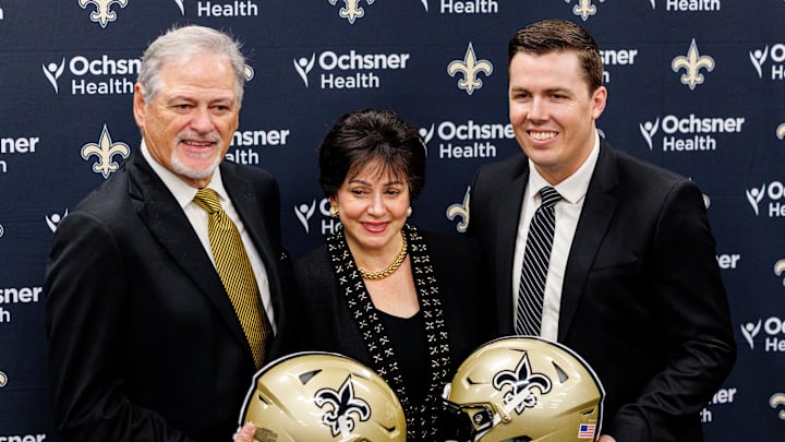Feb 13, 2025; New Orleans, LA, USA;  New Orleans Saints owner Gayle Benson and general manager Mickey Loomis pose with the new head coach Kellen Moore at Ochsner Sports Performance Center. Mandatory Credit: Stephen Lew-Imagn Images