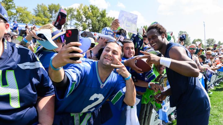 Jul 30, 2023; Renton, WA, USA; Seattle Seahawks quarterback Geno Smith (7) takes a selfie with fans after practice at the Virginia Mason Athletic Center. Mandatory Credit: Steven Bisig-USA TODAY Sports