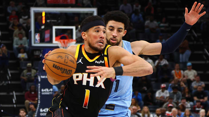 Phoenix Suns guard Devin Booker drives to the basket as Memphis Grizzlies guard Scotty Pippen Jr. defends. Phoenix Suns guard Devin Booker drives to the basket as Memphis Grizzlies guard Scotty Pippen Jr. defends.