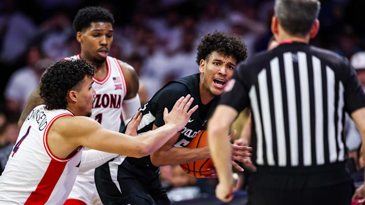 Jan 27, 2025; Tucson, Arizona, USA; Iowa States Cyclones guard Curtis Jones (5) calls a timeout while Arizona Wildcats guard Caleb Love (1) and forward Trey Townsend (4) defend during the second half at McKale Center. Mandatory Credit: Aryanna Frank-Imagn Images
