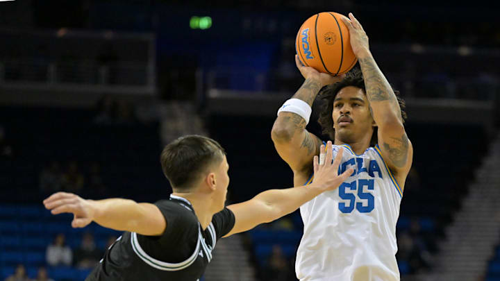 Dec 19, 2025; Los Angeles, California, USA; UCLA Bruins guard Skyy Clark (55) is defended by Cal Poly Mustangs guard Peter Bandelj (9) as he shoots a 3-point basket during the first half at Pauley Pavilion presented by Wescom Financial. Mandatory Credit: Jayne Kamin-Oncea-Imagn Images Dec 19, 2025; Los Angeles, California, USA; UCLA Bruins guard Skyy Clark (55) is defended by Cal Poly Mustangs guard Peter Bandelj (9) as he shoots a 3-point basket during the first half at Pauley Pavilion presented by Wescom Financial. Mandatory Credit: Jayne Kamin-Oncea-Imagn Images