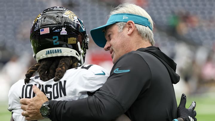 Sep 29, 2024; Houston, Texas, USA; Jacksonville Jaguars head coach Doug Peterson hugs running back D'Ernest Johnson (2) before the Jaguars play against the Houston Texans at NRG Stadium. Mandatory Credit: Thomas Shea-Imagn Images