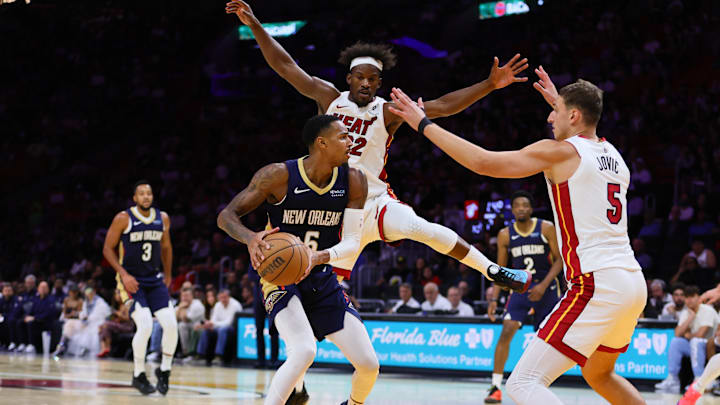 New Orleans Pelicans guard Dejounte Murray (5) drives to the basket against Miami Heat forward Nikola Jovic (5) and forward Jimmy Butler (22) during the second quarter at Kaseya Center. 