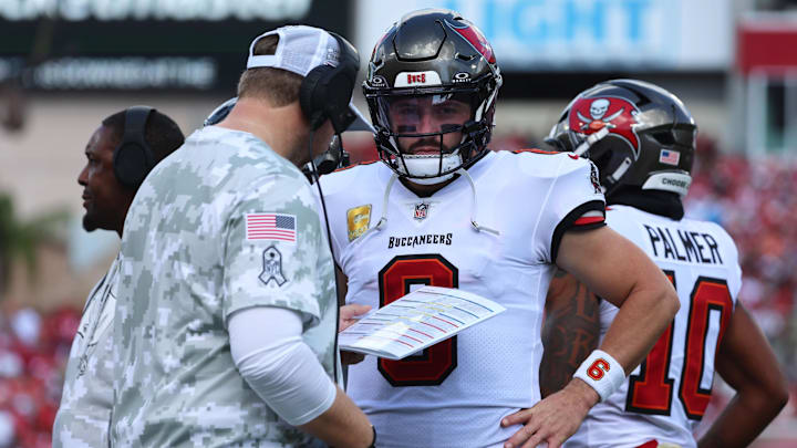 Nov 10, 2024; Tampa, Florida, USA; Tampa Bay Buccaneers quarterback Baker Mayfield (6) talks with offensive coordinator Liam Coen during the first half against the San Francisco 49ers at Raymond James Stadium. Mandatory Credit: Kim Klement Neitzel-Imagn Images