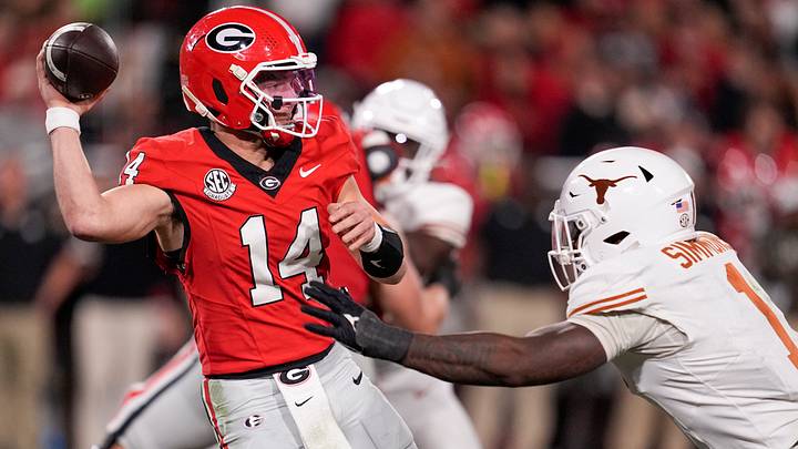 Georgia Bulldogs QB Gunner Stockton is pressured by Texas DL Colin Simmons. Georgia Bulldogs QB Gunner Stockton is pressured by Texas DL Colin Simmons.